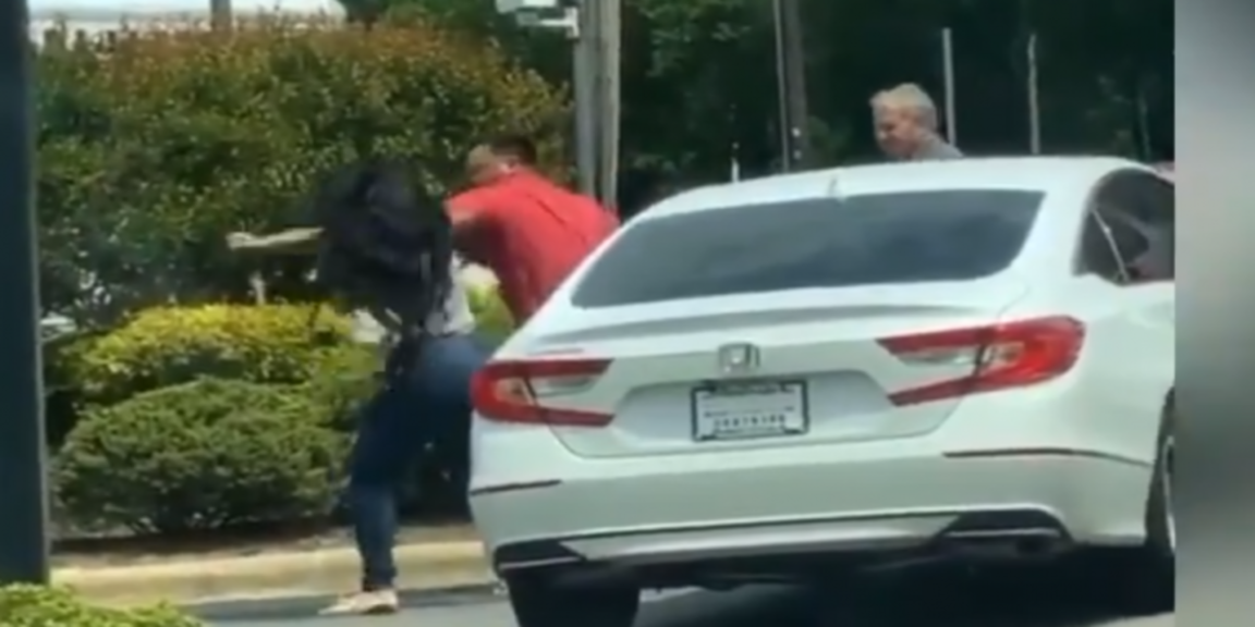 Man and woman spit on each other and exchange punches in gas line altercation