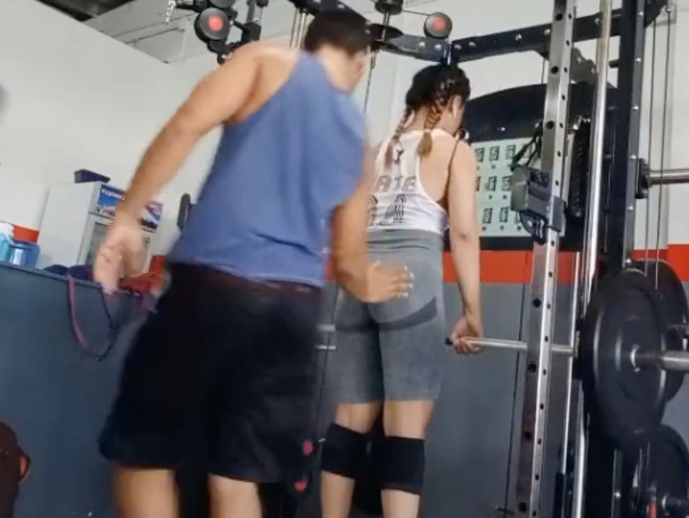 A man groped a woman's butt while lifting weights
