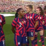 U.S. soccer players walk away from national anthem being played by World War II veteran