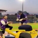 A woman runs away from her partner's marriage proposal at a baseball stadium