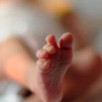 Newborn baby abandoned with umbilical cord in a public square