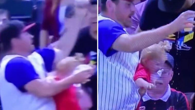 Dad almost drops his son while trying to catch a baseball