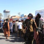 Taliban hang a corpse from a crane in the main square of the Afghan city