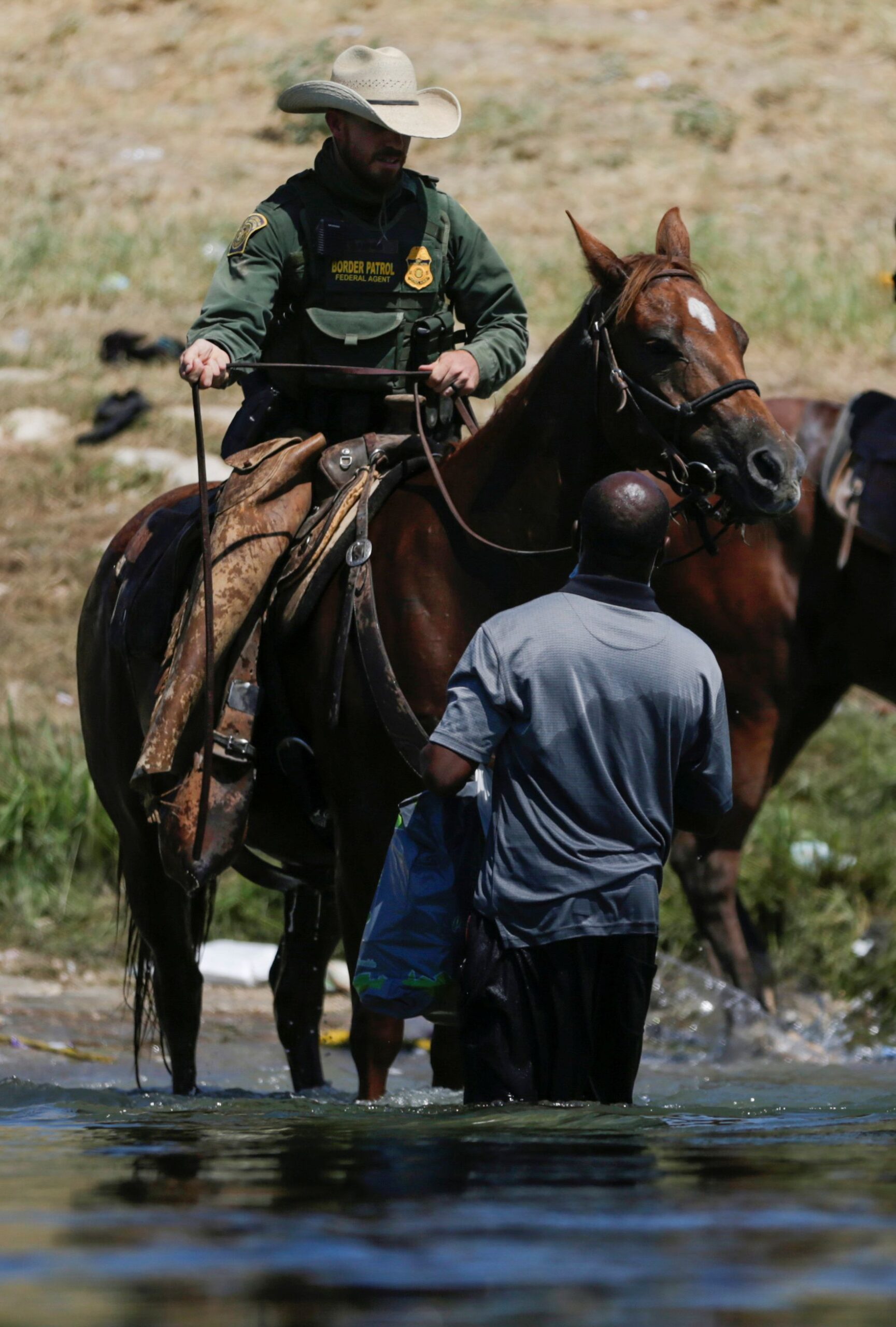 Border police on horseback use the whip on migrants seeking asylum