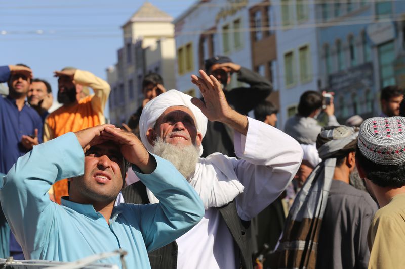 Taliban hang a corpse from a crane in the main square of the Afghan city