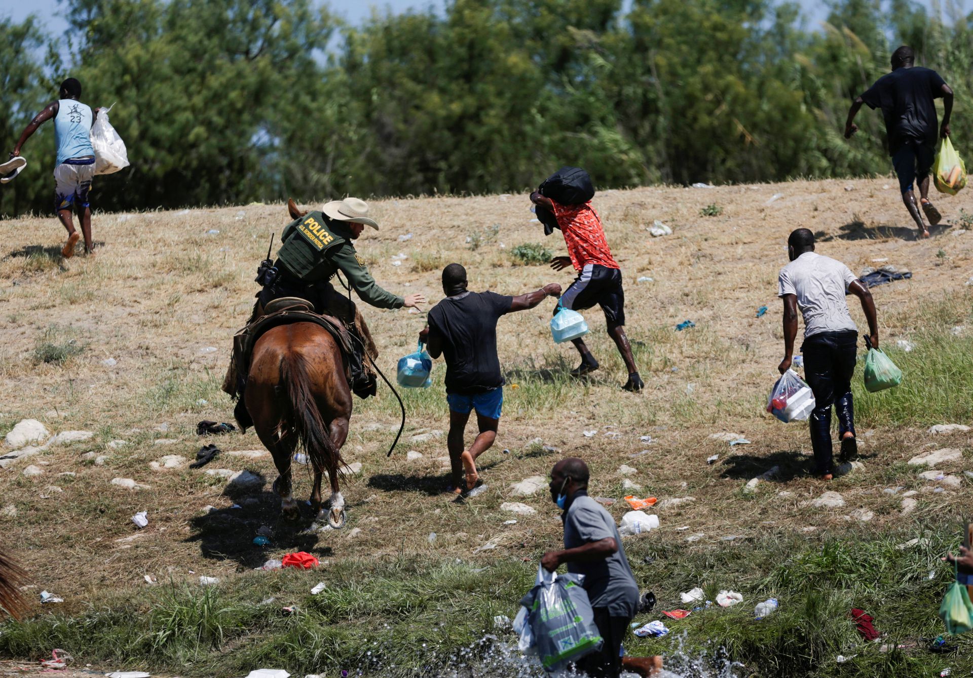 Border police on horseback use the whip on migrants seeking asylum