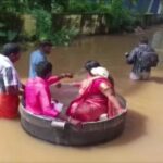 Desperate to get married, Indian couple floats in large pot to reach their wedding after flooding