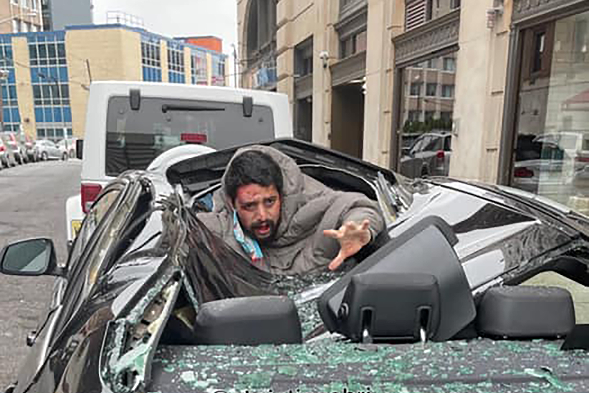 A man plunged nine stories from a skyscraper, crashed through the roof of a BMW and miraculously survived