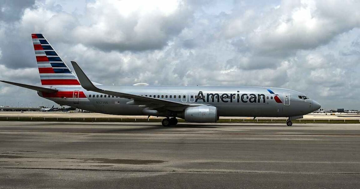 An American Airlines passenger opens the emergency exit and jumps onto the plane's wing in Miami
