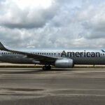 An American Airlines passenger opens the emergency exit and jumps onto the plane's wing in Miami