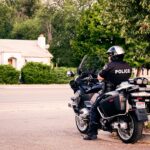 A police sergeant grabs a female officer by the throat